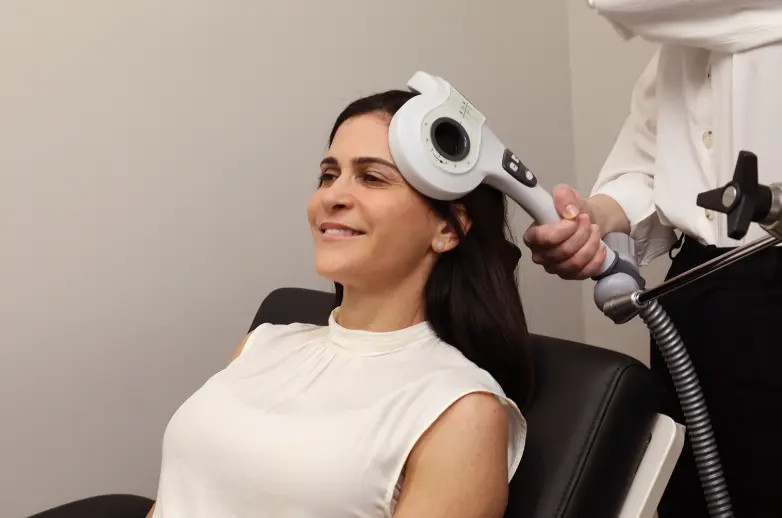 individualized-tms-treatment-west-virginia woman receiving TMS treatment in West Virginia