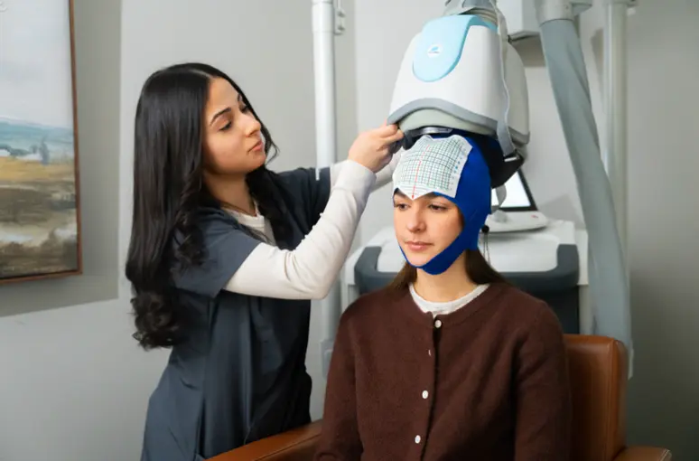 west-virginia-tms-individualized-program therapist guiding patient through TMS therapy in West Virginia
